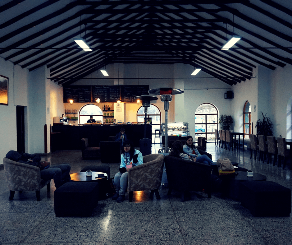 Inside the Poroy train station, small cafe, seats.