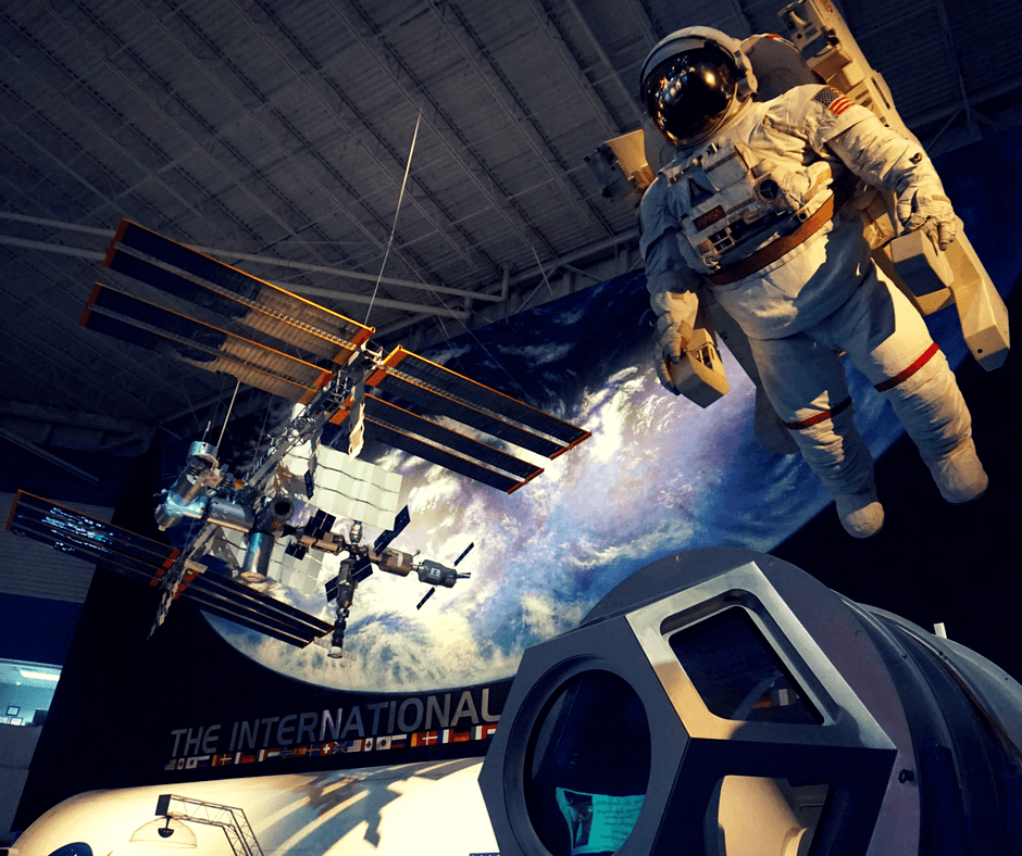 Astronaut and satellite inside Space Center Houston