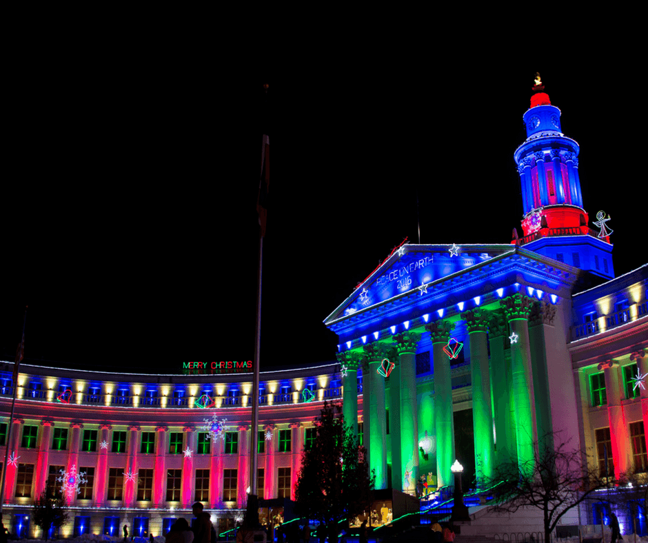 Denver City and County Building lit up in red and green holiday lights