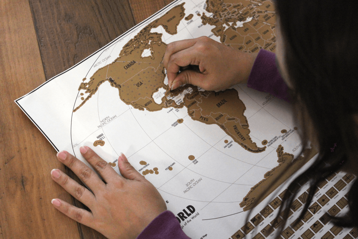 scratching off countries on world travel tracker map