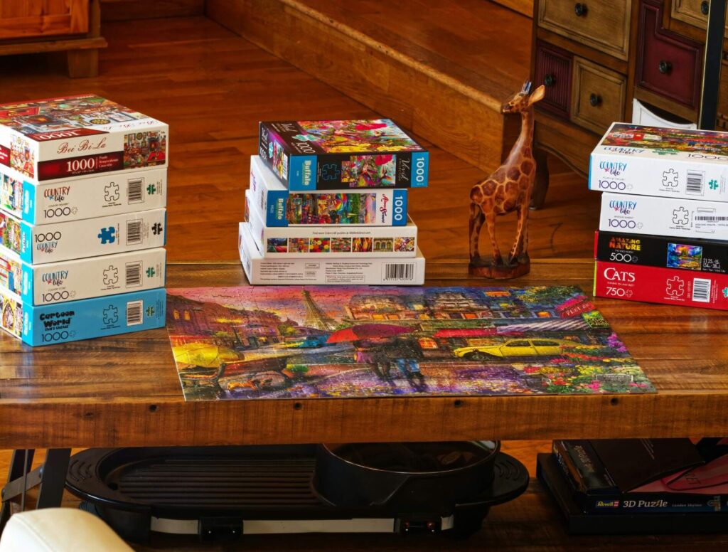Table with multiple boxes of puzzles
