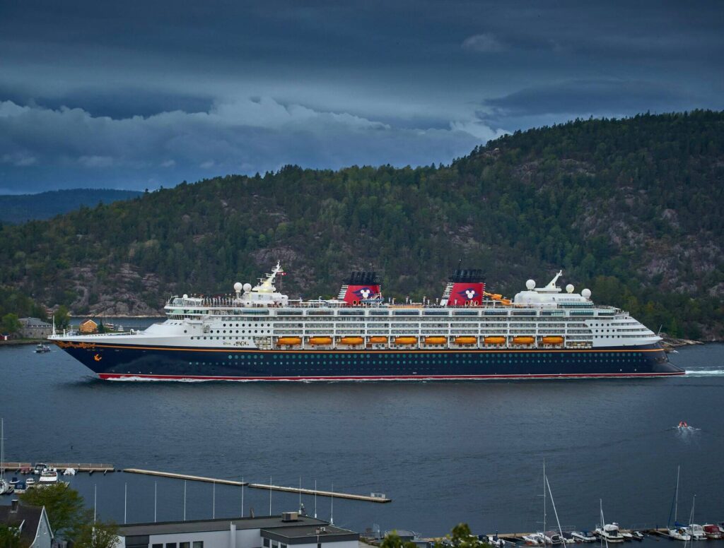 Cruise ship docked along hills