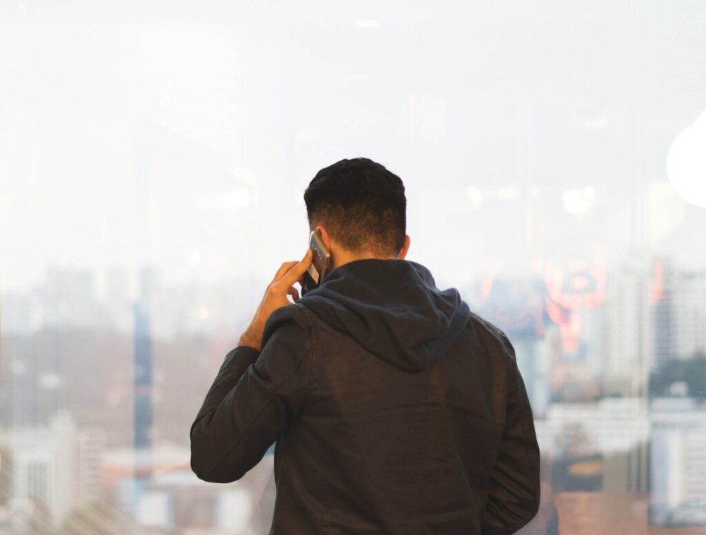Man facing away from camera while making a phone call