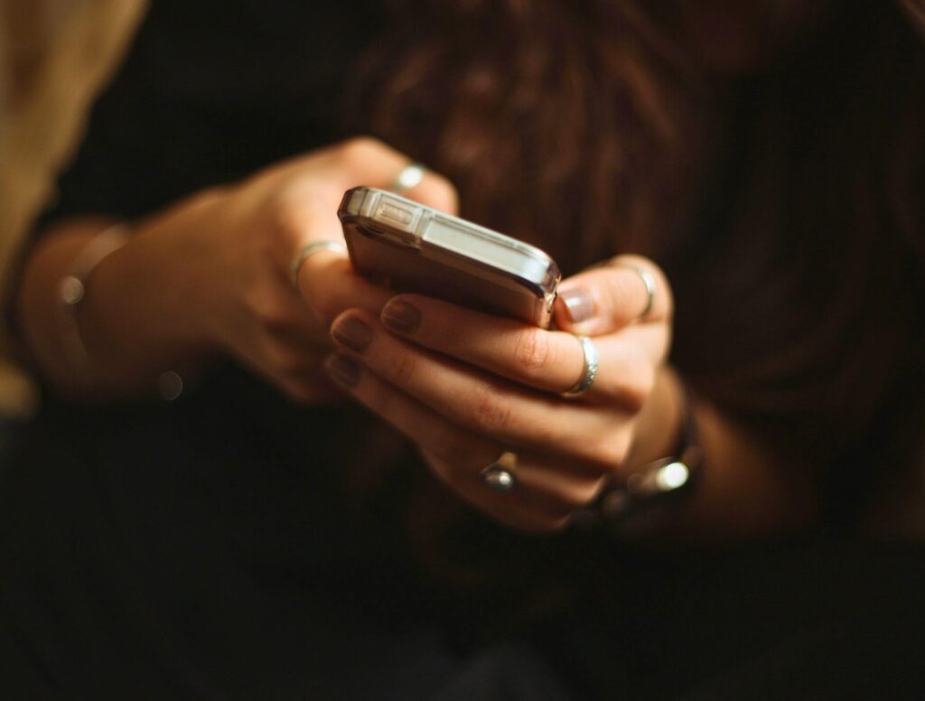 Woman holding cell phone in her hands