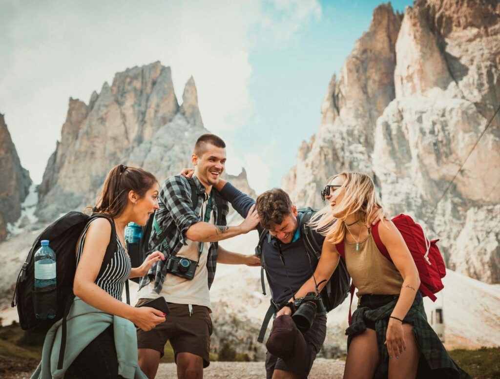 group of friends laughing together while hiking