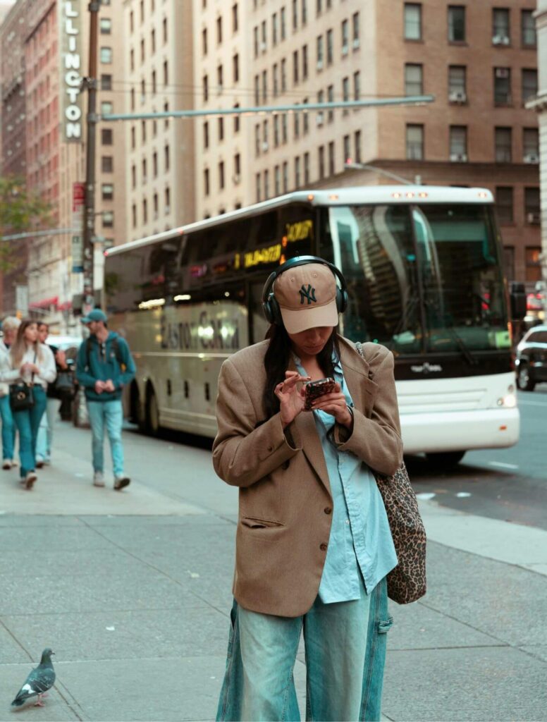 woman using her cell phone with cityscape in the background