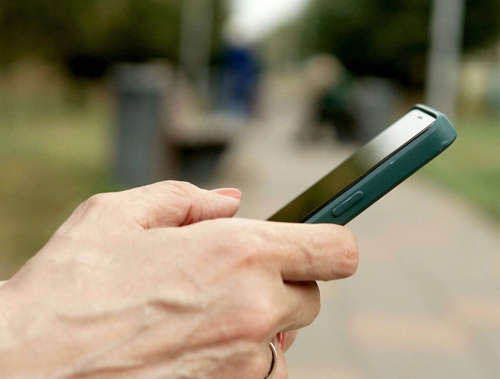 close up of hand using a cell phone